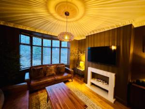a living room with a couch and a fireplace at Tudhoe Park Villas in Spennymoor