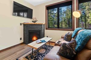 a living room with a couch and a fireplace at Suite Ucluelet in Ucluelet