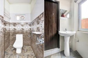 a bathroom with a toilet and a sink at Collection O MVP Double Road in Visakhapatnam