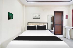 Ένα ή περισσότερα κρεβάτια σε δωμάτιο στο Collection O MVP Double Road +19 φωτογραφίες