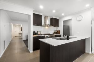 a kitchen with a sink and a counter top at Family-Friendly 4BR Mount Duneed Manor in Mount Duneed