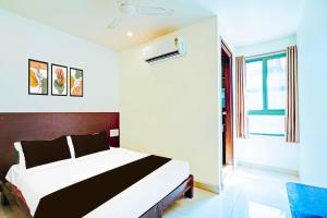 a bedroom with a large bed in a room at Collection O Kaveri Road Mysore in Mysore