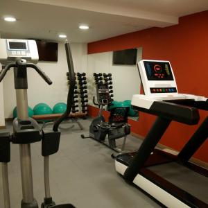 a gym with a treadmill and exercise equipment at The Place Hotel in Quito +9 photos