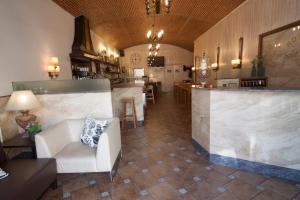 a lobby with a bar and a white couch at Hotel Sant Roc in Camprodon