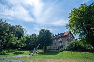 an old building in the middle of a field at Barrique Livezii in Braşov