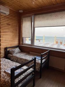 a bedroom with two beds and a view of the beach at Liberty of the Seas in Odesa