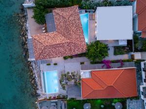 an aerial view of a house with orange roofs at Melivia Seafront Resort in Nea Skioni