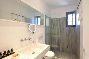 a bathroom with a sink and a toilet and a shower at Orloff Resort in Spetses