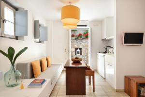 a kitchen and a living room with a table at Orloff Resort in Spetses