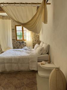a bedroom with a white bed and a window at Mediterranean Suite in Ardèche in Saint-Georges-les-Bains