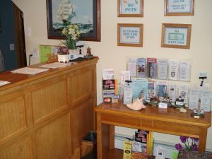 a room with a desk with books on the wall at Atlantic Motel in Point Pleasant Beach