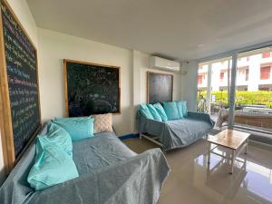 a room with two beds and a chalkboard on the wall at Blue Horizon Hostel By Blue Flow in Phi Phi Islands