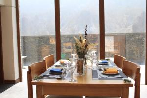 a dining room table with a view of a mountain at Mountain Lodges of Nepal Manang in Manangbhot