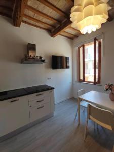 a kitchen with a table and a dining room at La Casa di Adele AFFITTACAMERE in Porto SantʼElpidio +19 photos