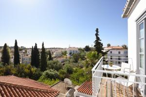 a balcony with a view of a city at Orloff Resort in Spetses
