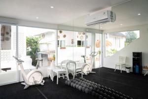 a room with a bunch of exercise equipment in it at Antana Hotel in Canggu