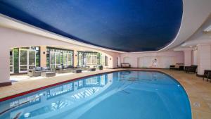 a large swimming pool with a large ceiling at Unit 21 - 3 Bed Part Ocean View in Terrigal +1 photo