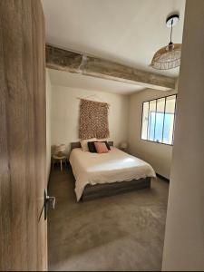 a bedroom with a large bed in a room at Appartement en rez-de-jardin in La Valette-du-Var