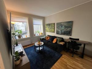 a living room with a couch and a table at Cozy Gem in the Heart Of Bergen in Bergen