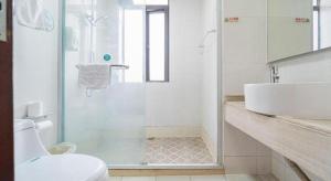a bathroom with a shower and a toilet and a sink at GreenTree Alliance Shanghai Railway Station QiuJiang Road Hotel in Shanghai +224 photos