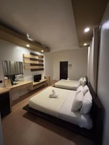 a large bedroom with two beds and a bathroom at Seabird International Resort in Boracay