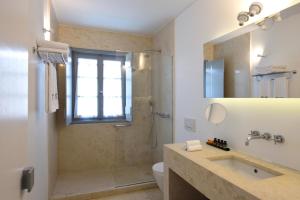 a bathroom with a shower and a sink and a toilet at Orloff Resort in Spetses