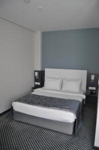 Postel nebo postele na pokoji v ubytování Cavit Duvan Prestige Hotel