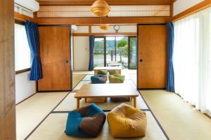 a living room with a table and two chairs at VillaLakeIrodori in Fujikawaguchiko