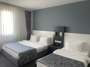 Postel nebo postele na pokoji v ubytování Cavit Duvan Prestige Hotel