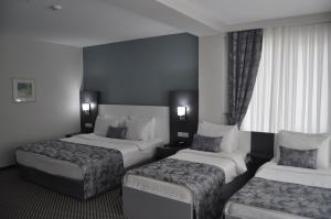 Postel nebo postele na pokoji v ubytování Cavit Duvan Prestige Hotel