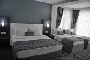 Postel nebo postele na pokoji v ubytování Cavit Duvan Prestige Hotel