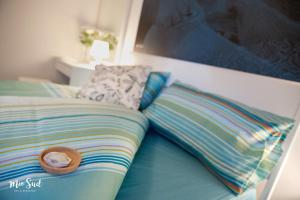 a hat sitting on a bed with two pillows at Mio Sud in Cosenza +19 photos