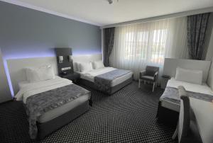 Postel nebo postele na pokoji v ubytování Cavit Duvan Prestige Hotel