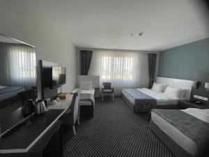 Postel nebo postele na pokoji v ubytování Cavit Duvan Prestige Hotel