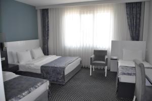 Postel nebo postele na pokoji v ubytování Cavit Duvan Prestige Hotel