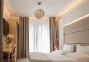a hotel room with a bed and a window at Hotel Ambassador in Rimini