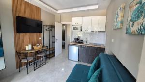 a kitchen and a living room with a small table at Agia Lydia Sea View Suite House in Karianí