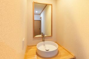 a bathroom with a white sink with a mirror at VillaLakeIrodori in Fujikawaguchiko +49 photos
