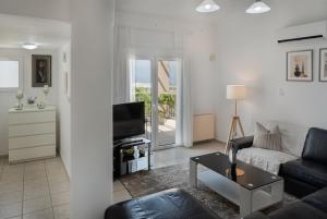 a living room with a couch and a table at Phaedrus Living Seaview Hilltop Maisonette in Chlorakas