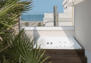 a bathroom with a sink and a view of the ocean at Hotel Ambassador in Rimini