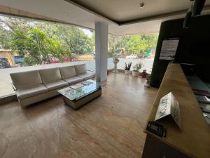 a living room with a couch and a table at Hotel Apex Intercontinental in Jaipur