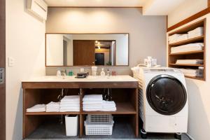 a bathroom with a sink and a washing machine at VillaLakeIrodori in Fujikawaguchiko