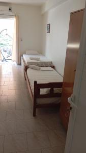 Postel nebo postele na pokoji v ubytování IN Himaras Heart Hotel