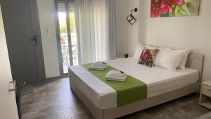 a bedroom with a bed with towels on it at Harmony Studios & Apartments in Skala Potamias +79 photos
