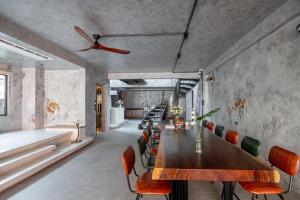 a dining room with a wooden table and chairs at The Common Room in Ho Chi Minh City