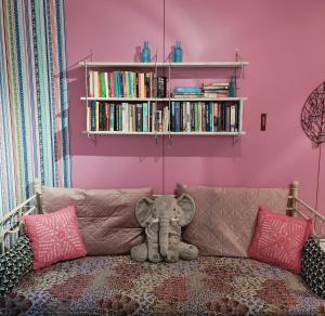 a stuffed elephant sitting on a couch in a room at Piha-aitta taajamassa in Parikkala
