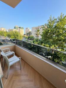 a balcony with a chair and a view of a city at Vila Huqi Seaside in Durrës