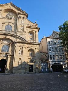 a large stone building next to two other buildings at Art House Olymp in Bamberg