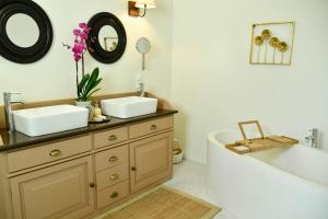 a bathroom with a tub and a sink and a bath tub at Villa Evanna in Lefkimmi