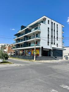 a large white building on the side of a street at Sea Panorama Apartments & Free Parking in Năvodari